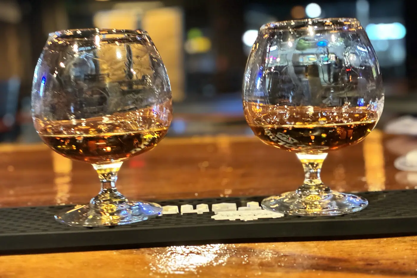 Two whiskey glasses on the bar